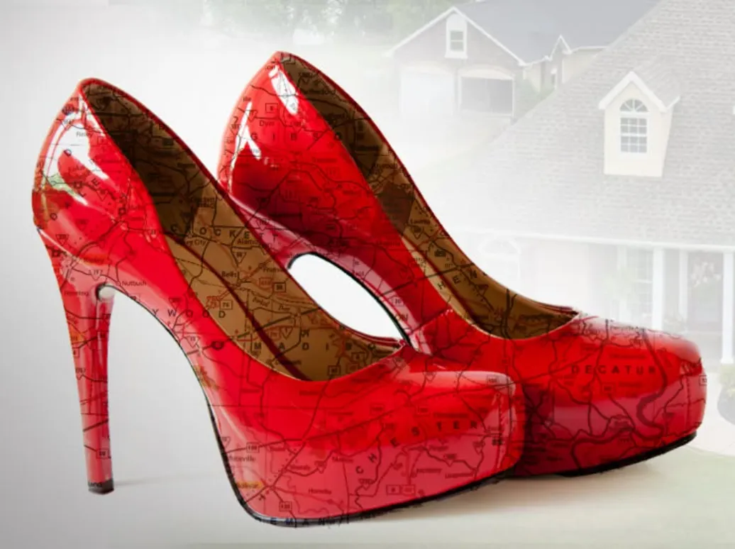 Red patent stilettos printed with the West Tennessee road map, in front of a brick home, with the Kimberly Evans and Coldwell Banker Southern Realty logos